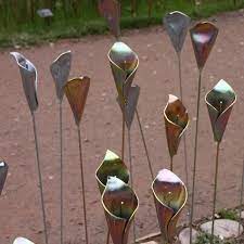 Handmade from recycled spigot handles using bent steel and driftwood. Diy Metal Flowers Metal Flowers Metal Garden Art Metal Flower Art
