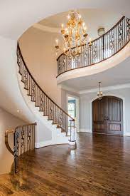 Love The Wrought Iron Railing On The Curved Stair Case And Open Stairway To The Basement Courtesy Of Www Hupkateam Com S Stairs Stairways Stair Railing Design