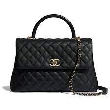 Since the boy bag by chanel was first created, the style has been revisited in different sizes and materials. Maxi Flap Bag With Top Handle Grained Calfskin Gold Tone Metal Chanel