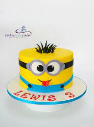 A tall round cake with yellow and blue buttercream frosting with an edible minion cake topper two tier minion cake. Minion Cake Strawberry Butter Cake With Strawberry Buttercream Was The Strict Instructions Of My 3 Year Old Minion Birthday Cake Birthday Cake Kids Minion Cake