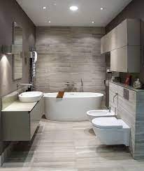 The brass mirror really stands out against the gray wallpaper while the two brown nickel and glass wall sconces tie it all together. Ah Grey Bathroom Ideas Pinterest Modern Bathroom Design Modern Bathroom Small Bathroom Remodel