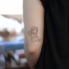 The cherub tattoos are worn by people as a symbol of love, hope and protection. Fine Line Cherub Tattoo On The Tricep