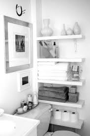 Bathroom Floating White Wooden Four Shelves For Towels And Tissue Paced On The White Wall Wonderful Wh Bathroom Storage Solutions Small Bathroom Storage Home
