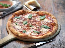 Next, preheat the oven to approximately 475 degrees fahrenheit. How To Use A Pizza Stone In The Oven Cooking School Food Network