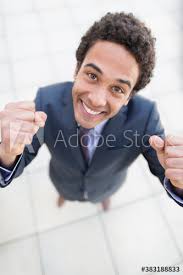 Free: Smiling young businessman pointing his finger against grey background  Free Photo