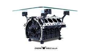 It features a 4.6 liter ford mustang modular engine block as it's base with the cylinder pistons welded in place to hold up a clear glass coffee table top. Stunning Porsche V8 Engine Coffee Table By Engine Table Uk