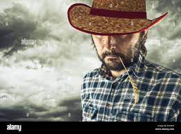 Cowboy with straw in mouth