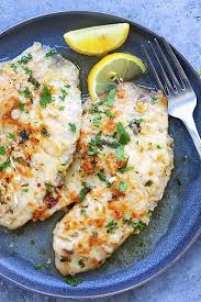 Parmesan Baked Tilapia Fish With Fresh Lemon Ready To Be Served Baked Tilapia Tilapia Recipes Best Tilapia Recipe