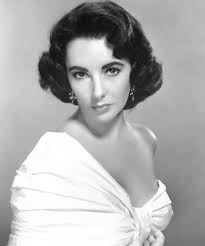 Fourteen years old Elizabeth Taylor wore a ruffled white dress with  matching gloves to sign autographs for fans outside a nightclub (1946)  Source: Country Living Magazine