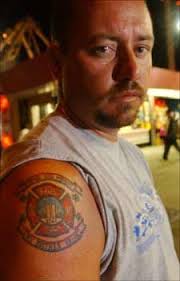A clock shows the birth date and time of one of his daughters. Police Tattoos