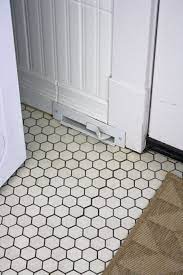 A black hexagon mosaic tile flooring with white grout defines the form of the ceramic tiles and also adds a layer of texture to the bathroom. My Laundry Mud Room Part 2 White Hexagon Tiles Laundry Mud Room Flooring