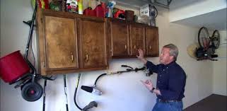 The cabinets, while white, were distressed and the upper cabinet. Reused Kitchen Cabinets Provide Storage Solution For Garage Today S Homeowner