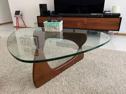 The table brings a simplistic yet iconic design that combines glass and natural wood to be the center of attention no matter where these are placed. High Quality Replica Noguchi Coffee Table Furniture Home Living Furniture Tables Sets On Carousell