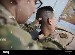 Lt. Col. Tisha Sutton, 332d Expeditionary Medical Group physical therapist,  guides a pilot from the 332d Expeditionary Fighter Squadron through a set  of flexibility exercises January 3, 2018 in Southwest Asia. Flying