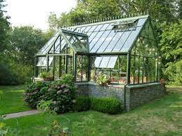 Small Sturdy Greenhouse With Glass Windows And Rain Collection Method Reclaimed Windows Backyard Greenhouse Greenhouse Garden Yard Ideas