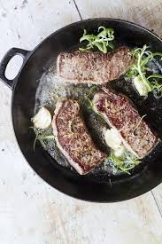 Steaks are ideal for cooking in an iron skillet because the pan browns the exterior without overcooking the. Garlic Rosemary Buttered Steak How To Cook Steaks Ginger With Spice