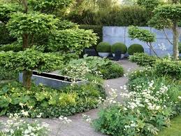 11 Ideas To Steal For A Moonlight Garden Gardenista Sloped Garden Shade Garden Chelsea Garden