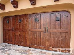 This tuscan style garage door was handcrafted in solid rustic alder wood with an oil rubbed finish and decorative iron hardware. Spanish Garage Doors Houzz