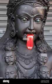Black statue of Hindu goddess Kali with a blood-dripping red tongue:  outside a shop for religious objects in Bamrung Muang Road, Bangkok,  Thailand Stock Photo