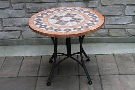 Brick patios with circular patterns create a subtle bullseye effect that can be charming or quite intriguing, as shown by the modern patio below. Side Tables Mosaic Side Table For Patio Black Iron Outdoor Accent Table Floral Pattern Design For Home Decor By Thy Hom Patio Lawn Garden