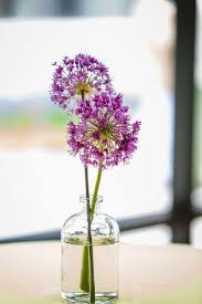 A Vase With Purple Dandelions Wedding Flower Arrangements Purple Wedding Flower Guide Wedding Flowers