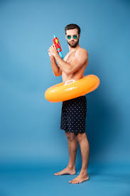 Serious man with water gun standing isolated | Free Photo