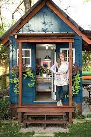 For outdoor storage sheds for sale with style and affordability, best in backyards is your ultimate partner. She Shed A Smiling Young Woman Standing In Front Of The Open Door Of A Small Garden House Painted In Da In 2020 Garden Shed Interiors Painted Shed Painted Garden Sheds
