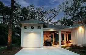 Achee Cottage is a Fairhope vernacular Southern cottage showcasing unique  features: casement windows with transoms, large overhang with open rafters,  floating beams with brackets, and a detached carport and garage. Designed  by: