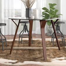 These pieces may feature wood or metal frames and a circular, square or rectangular surface. Foundstone Solomon Marilyn Glass Top Dining Table Reviews Wayfair