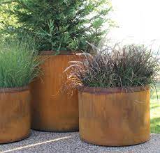 Shapes include square cubes, rectangles, and round tapered containers as well as more abstract shapes. Round Cor Ten Steel Planters Bentintoshape Net Large Outdoor Planters Large Planters Outdoor Planters