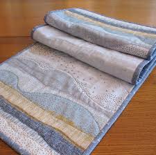 This Quilted Cotton Table Runner Has Shades Of Soft Grey And White Accented With Washed Indigo Blu Blue Table Runner Quilted Table Runners Modern Table Runners