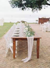 Farm Wood Head Table With Adorn Runner Eucalyptus Garland And White Folding Chairs Head Table Wedding White Chairs Wedding White Folding Chairs