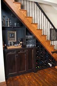 Make good use of that unused area under the stairs, whether it's in your entry or basement! Fascinating Dark Black Staircase Design With Dark Wine Storage Under Stairs Featured With Open Shelves To Displa Basement Remodeling House Design Bars For Home
