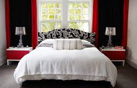 Red reclining sofa set with red and white accent pillows combined with black lamps and a black and gray rug. Red Black And White Interiors Living Rooms Kitchens Bedrooms