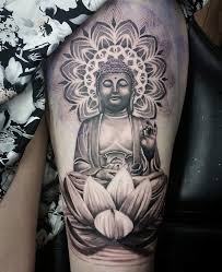 To buddhists, the lotus represents the purity of enlightenment after the long toil of earthly existence because the pure, white flowers of the lotus unfold each morning out of muddy, standing water. Black Ink Asian Buddha With Lotus Flower Tattoo Design For Thigh