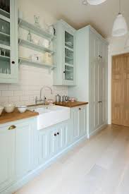 Mint Green Kitchen Cabinets With Butcher Block Counters And White Farmhouse Sink In 2020 Green Kitchen Cabinets Farmhouse Kitchen Inspiration Farmhouse Style Kitchen