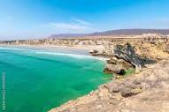 The Omani village of Taqah and it's white sandy Taqah Beach seen ...