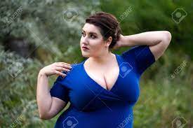 Sexy Plus Size Fashion Model In Blue Dress With A Deep Neckline Outdoors,  Beautiful Fat Woman With Big Breasts In Nature, Body Positive Concept Stock  Photo, Picture and Royalty Free Image. Image