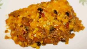 Like A Giant Baked Taco Ground Beef With Ranch Style Beans And Tomatoes On Top Of Corn Tortill Mexican Casserole Beef Casserole Recipes Mexican Beef Casserole