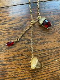 The acorn charm hangs on 24″ chain. Gold Acorn Necklace Gem