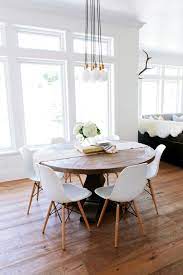 Add modern farmhouse style to your home with the. A Rustic Round Wood Table Surrounded By White Eames Dining Chairs Creates An Interesting Mix In A Transit Eames Dining Farmhouse Dining Room Rustic Round Table