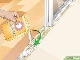Spread a baking soda paste over your shower doors, then activate with vinegar. 3 Ways To Clean Sliding Glass Door Tracks Wikihow