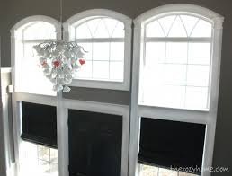 Arched windows over sink with roman shade and molding connecting to cabinets. Remodelaholic How To Install Molding And Trim On Arched Windows