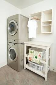 Loving The Stackable Front Loaders To Save More Space And The Folding Table With Laundry Basket S Laundry Room Decor Laundry Room Storage Small Laundry Rooms