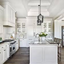 White Raised Panel Kitchen Cabinets With White Mini Subway Tile Backsplash Farmhouse Kitchen Design White Kitchen Design Gorgeous White Kitchen