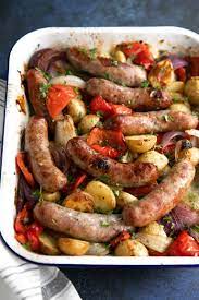Oven Roasted Sausage Potatoes Onion And Bell Pepper In A White Roasting Dish Italian Sausage Recipes Sausage Dishes Sausage Recipes For Dinner