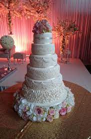 Roya Elegant 6 Tiered Cake Decorated With Lace And Other Effects On Each Tier And Finished Royal Wedding Cake Unique Wedding Cakes Contemporary Wedding Cakes