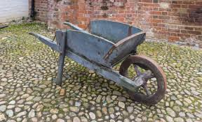 Has handles and one or more wheels. In Praise Of The Wheelbarrow Low Impact Transportation At Its Best Low Impact Living Info Training Products Services
