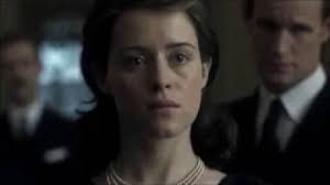 Why does Sir Anthony Eden hesitate to stand up in this scene?