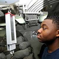 Ship's Serviceman 3rd Class Randy Teal, assigned to the Supply Department's  S-3 Division, weighs laundry in the ship's laundry room aboard the  Nimitz-class aircraft carrier USS Carl Vinson (CVN 70).